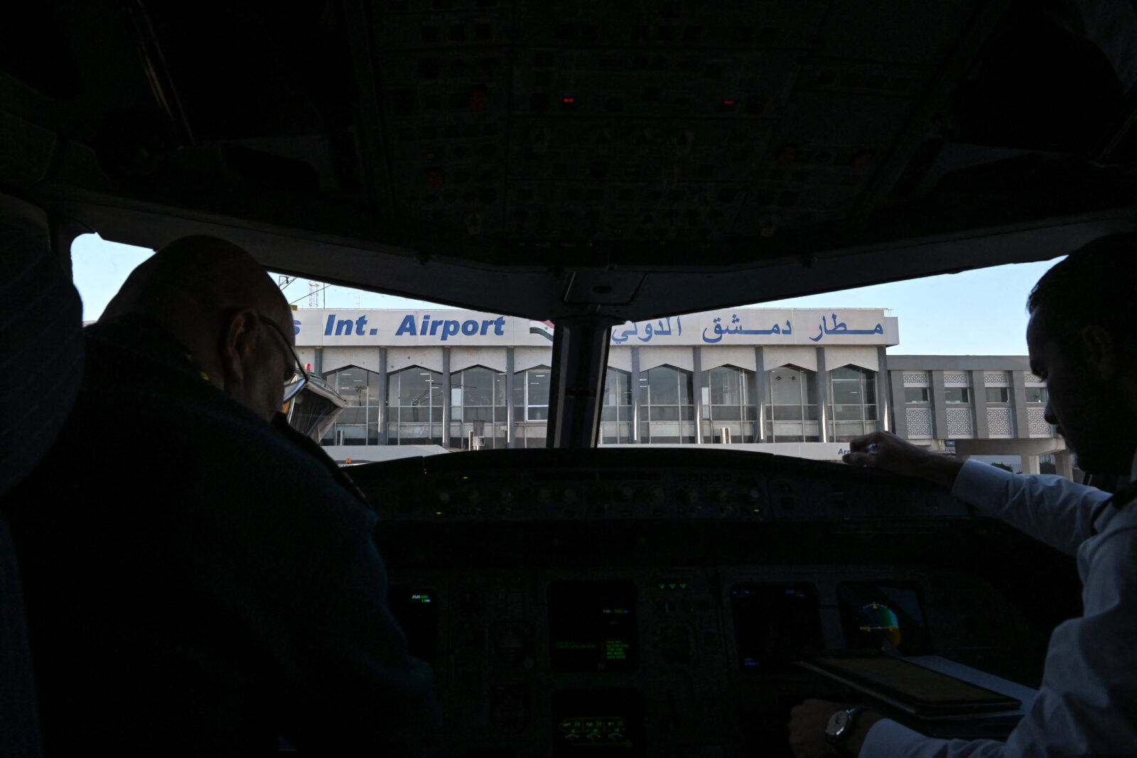 Pilots sit at the cockpit of a Syrian Air aircraft at Damascus International Airport before a flight to the city of Aleppo, on Dec. 18, 2024. (AFP Photo)
