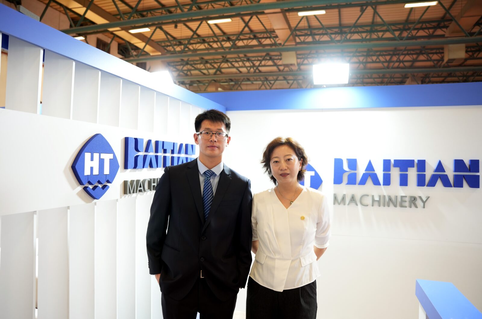 The Deputy Secretary-General of the China Plastic Machinery Industry Association, Cui Xinyou (L) poses at the Haitian Machinery stand, a China-based prominent plastic machinery firm, at the Istanbul Tuyap Fair and Congress Center in Istanbul, Türkiye, on Dec. 4, 2024. (IHA Photo)
