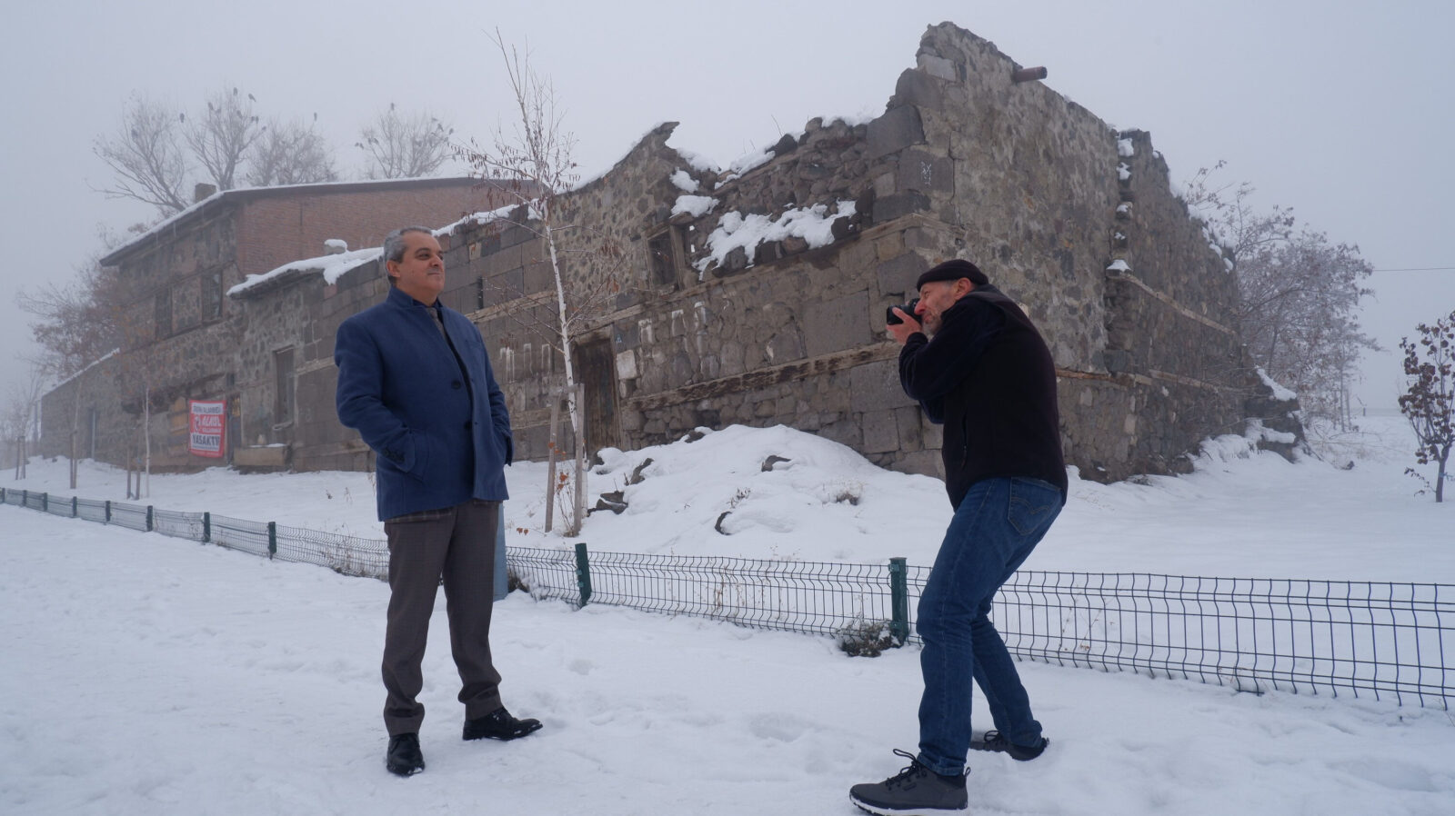 French anthropologist Victor d'Allant (R) takes a photo of Ahmet Ozmen at the same spot he photographed Ozmen as a kid 44 years ago, Erzurum, Türkiye, Dec. 11, 2024. (Türkiye Daily)