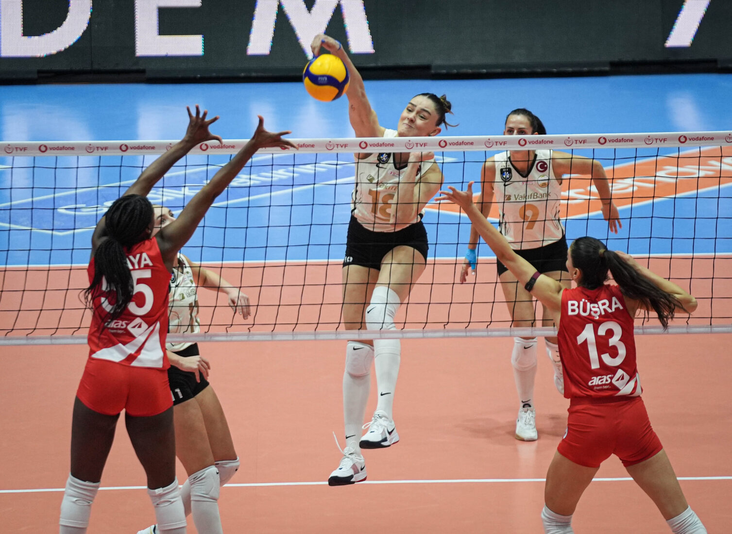 Aras Kargo's Ana Karina Olaya (55) and Busra Gunes (13) compete at the net with VakifBank's Zehra Gunes (18) during Vodafone Sultanlar Ligi 16th week match, Izmir, Türkiye, Jan. 14, 2025. (AA Photo)