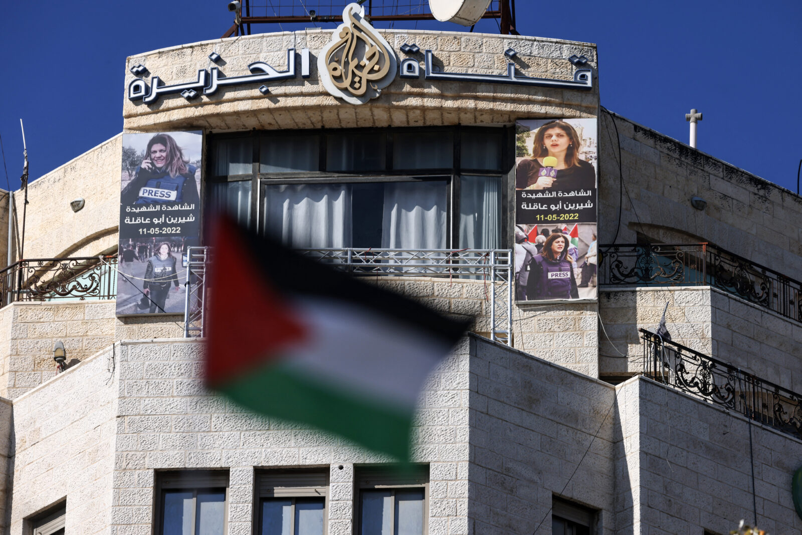 Pictures of slain Palestinian journalist Shireen Abu Akleh are hung across the facade of the building housing the Al-Jazeera TV channel in the occupied West Bank city of Ramallah on Jan. 2, 2025. - Authorities in Ramallah have ordered the suspension of broadcasts by Al Jazeera across the Palestinian territories, accusing the network of incitement, official media reported. (AFP Photo)