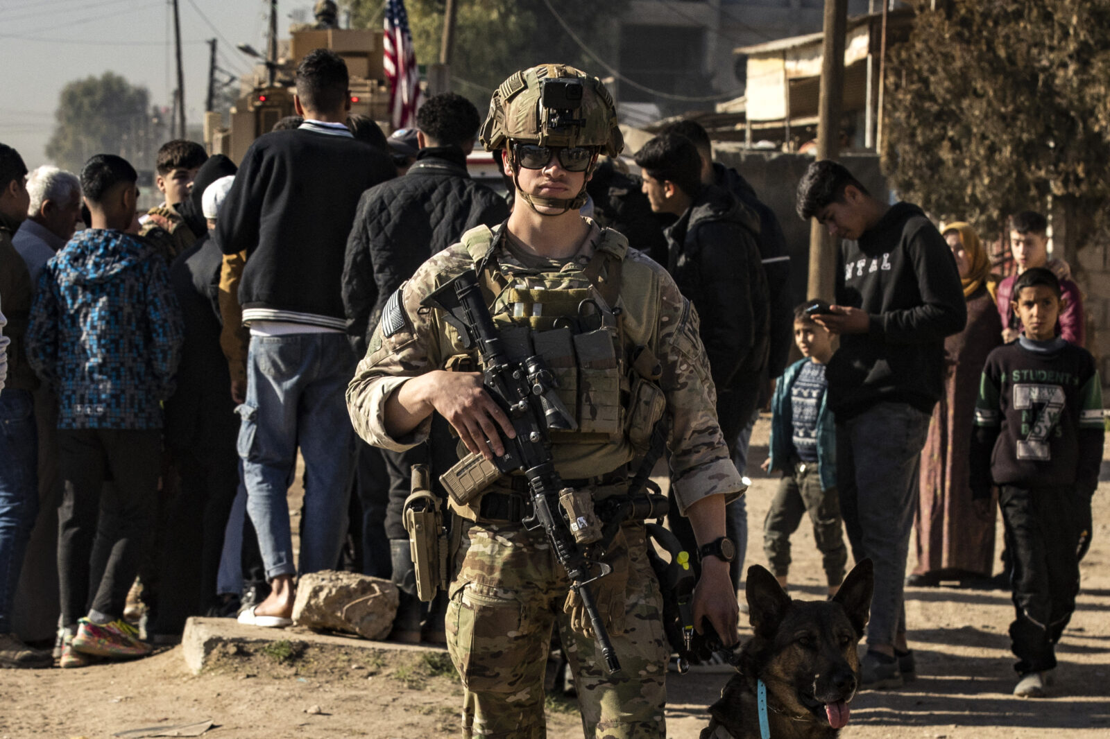 A U.S. soldier holds a dog as forces patrol in Syria's northeastern city Qamishli, in the Hassakeh province, mostly controlled by Kurdish-led SDF, on Jan. 9, 2025. (AFP Photo)