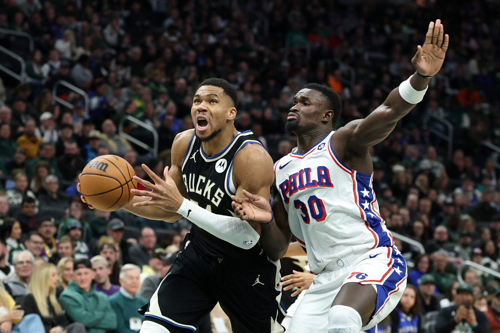 Giannis Antetokounmpo #34 of the Milwaukee Bucks is defended by Adem Bona #30 of the Philadelphia 76ers during the first half of a game at Fiserv Forum in Milwaukee, Wisconsin, Jan. 19, 2025. (AFP Photo)Adem Bona #30 of the Philadelphia 76ers shoots a free throw during the game against the Milwaukee Bucks at Fiserv Forum Center in Milwaukee, Wisconsin, Jan. 19, 2025. (AFP Photo)