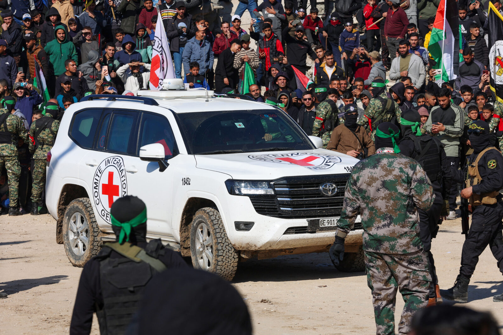 A Red Cross vehicle arrives in a square while Hamas fighters secure the area before releasing four Israeli hostages in Gaza City on January 25, 2025. (AFP Photo)