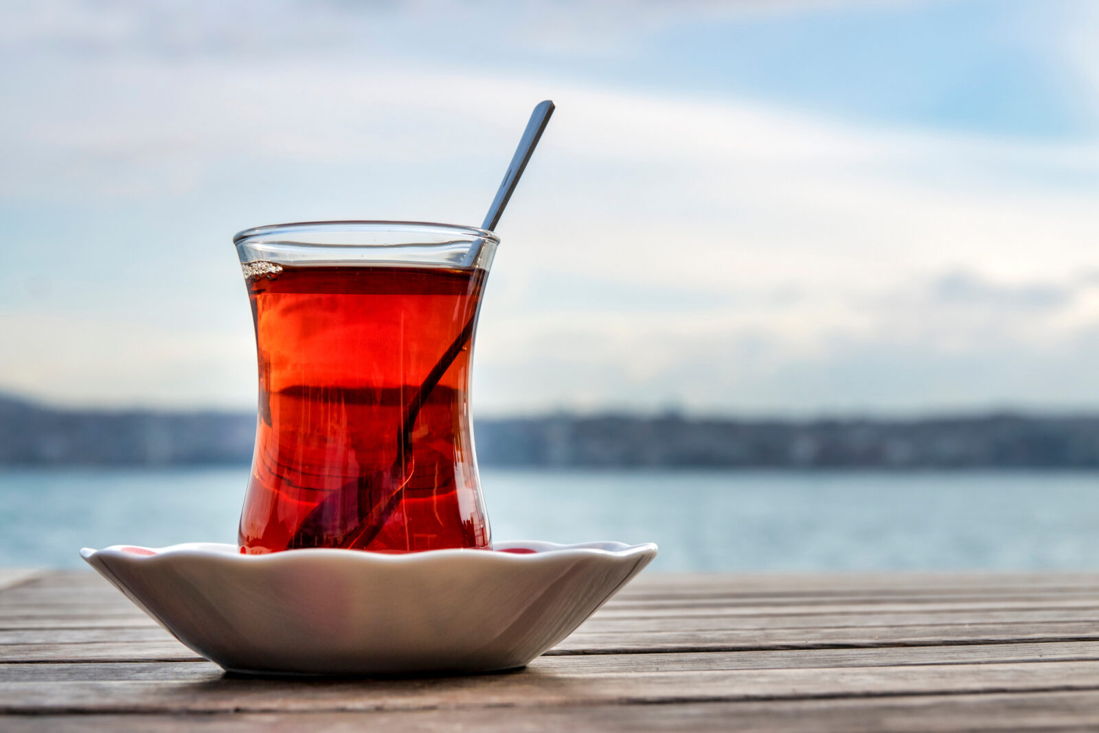 Turkish tea is served in the traditional way—steaming hot in a glass on a small saucer. (Adobe Stock Photo)