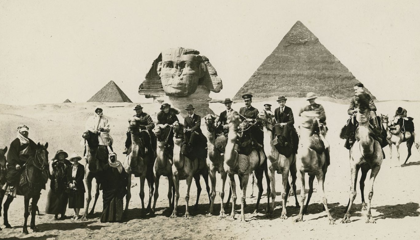 A group, including Winston and Clementine Churchill, Gertrude Bell, and TE Lawrence, on camels in front of sphinx and pyramids, during Cairo Conference, Egypt, March 21, 1921. (Photo via <a href=