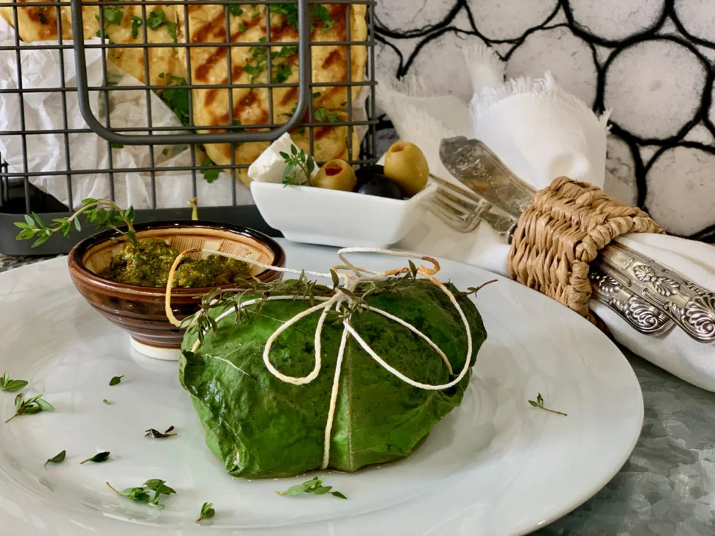 Bonito wrapped in fig leaves and ready to be cooked. (Photo via Whisk and Dine)
