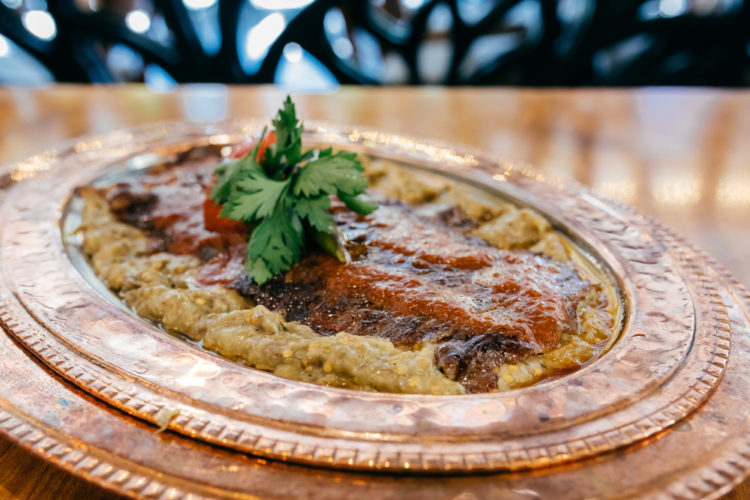 Sultan's Delight or Hunkar Begendi is a regal dish of smoked eggplant puree topped with tender, slow-cooked lamb or beef. (Adobe Stock Photo)