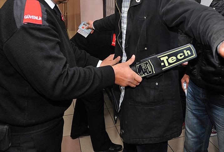 The file photo shows a security officer conducting a body scan with a handheld metal detector in Türkiye. (AA Photo)