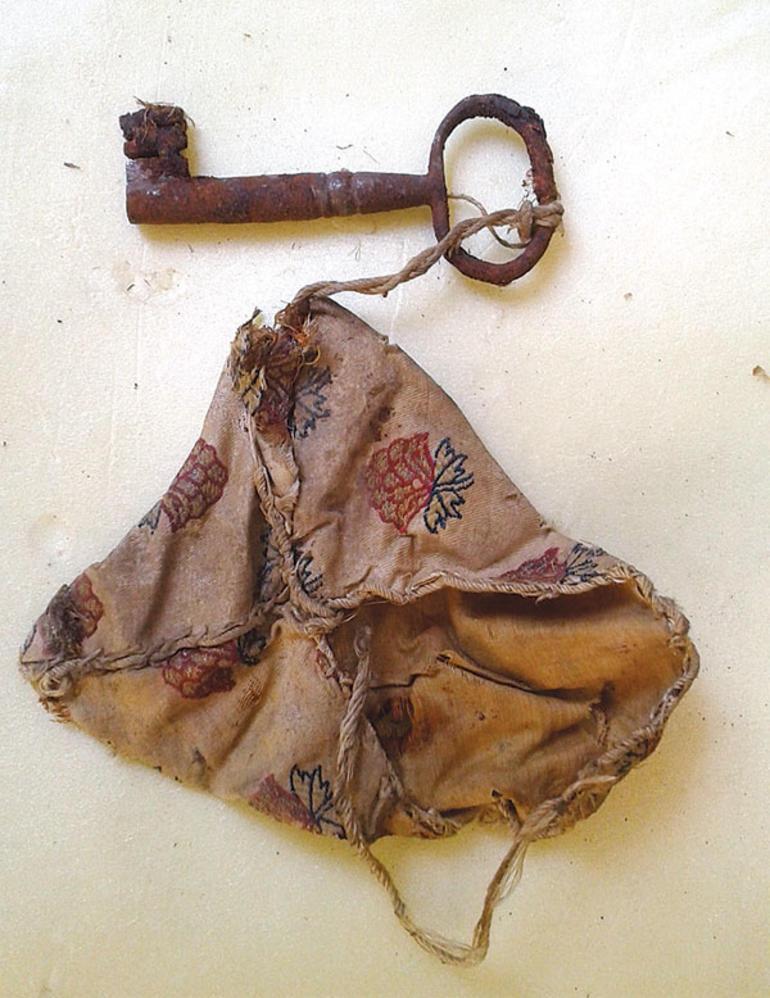 An Ottoman-era amulet placed for magical purposes and an attached key, discovered during restoration at Topkapi Palace, Istanbul, Türkiye. (Photo via Topkapi Palace Administration)