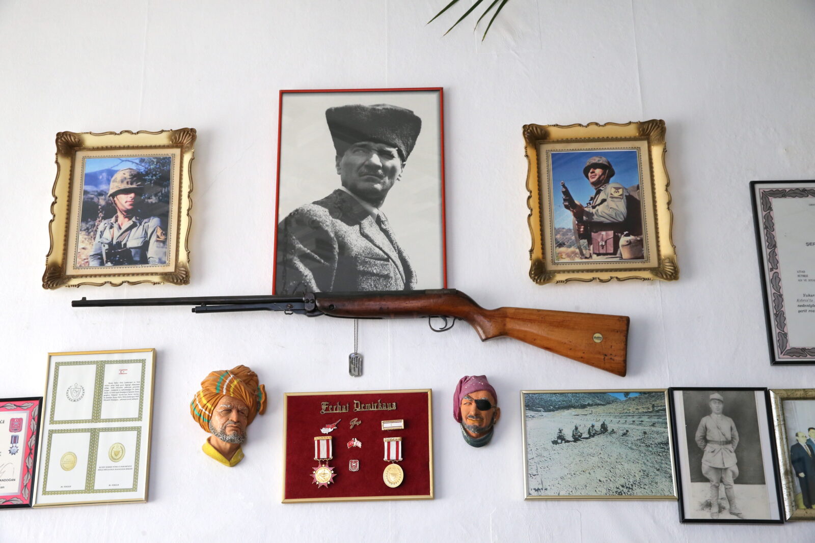 Cyprus Peace Operation veteran Ferhat Demirkaya has been keeping the rifle he received from a soldier, a small figurine from his home, and photographs taken at significant locations since the operation for 50 years. (AA Photo)