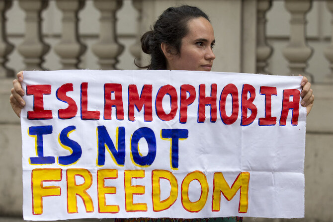 A protester holds a sign which reads 