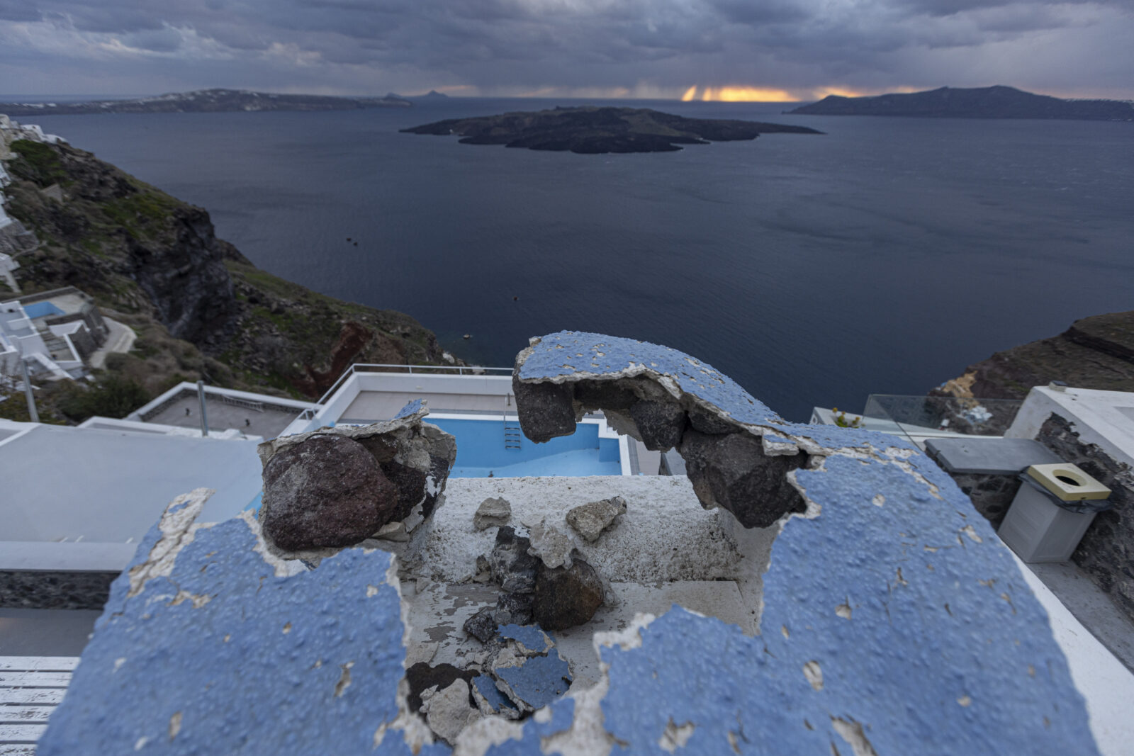 A damaged construction site, an empty pool, and Nea Kammeni islet on the Greek island of Santorini, Feb. 21, 2025. (AA Photo)
