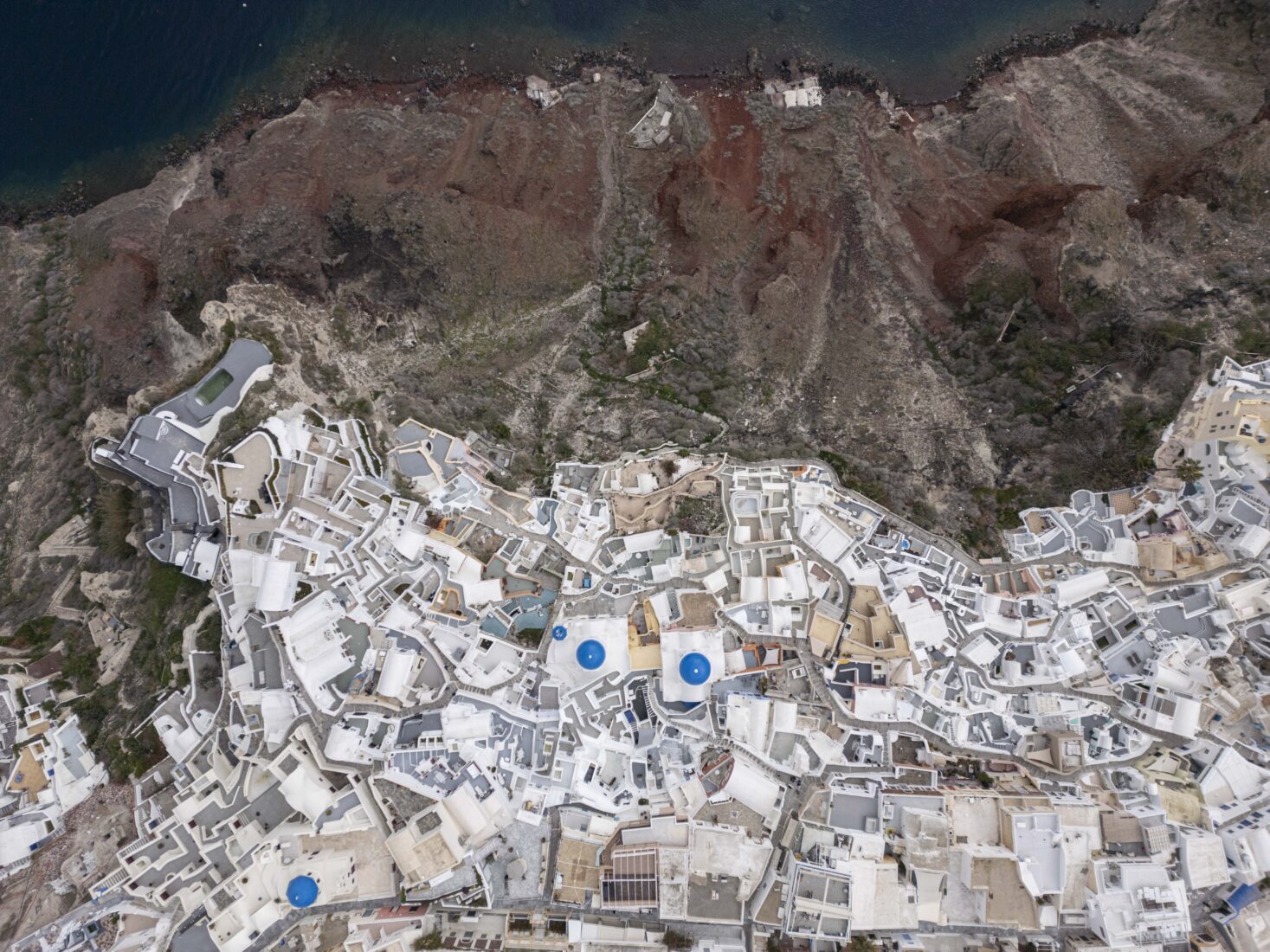 An aerial view of the Blue Domed Church and the village of Oia on Santorini Island, where seismic activity has been gradually decreasing, Feb. 21, 2025. (AA Photo)