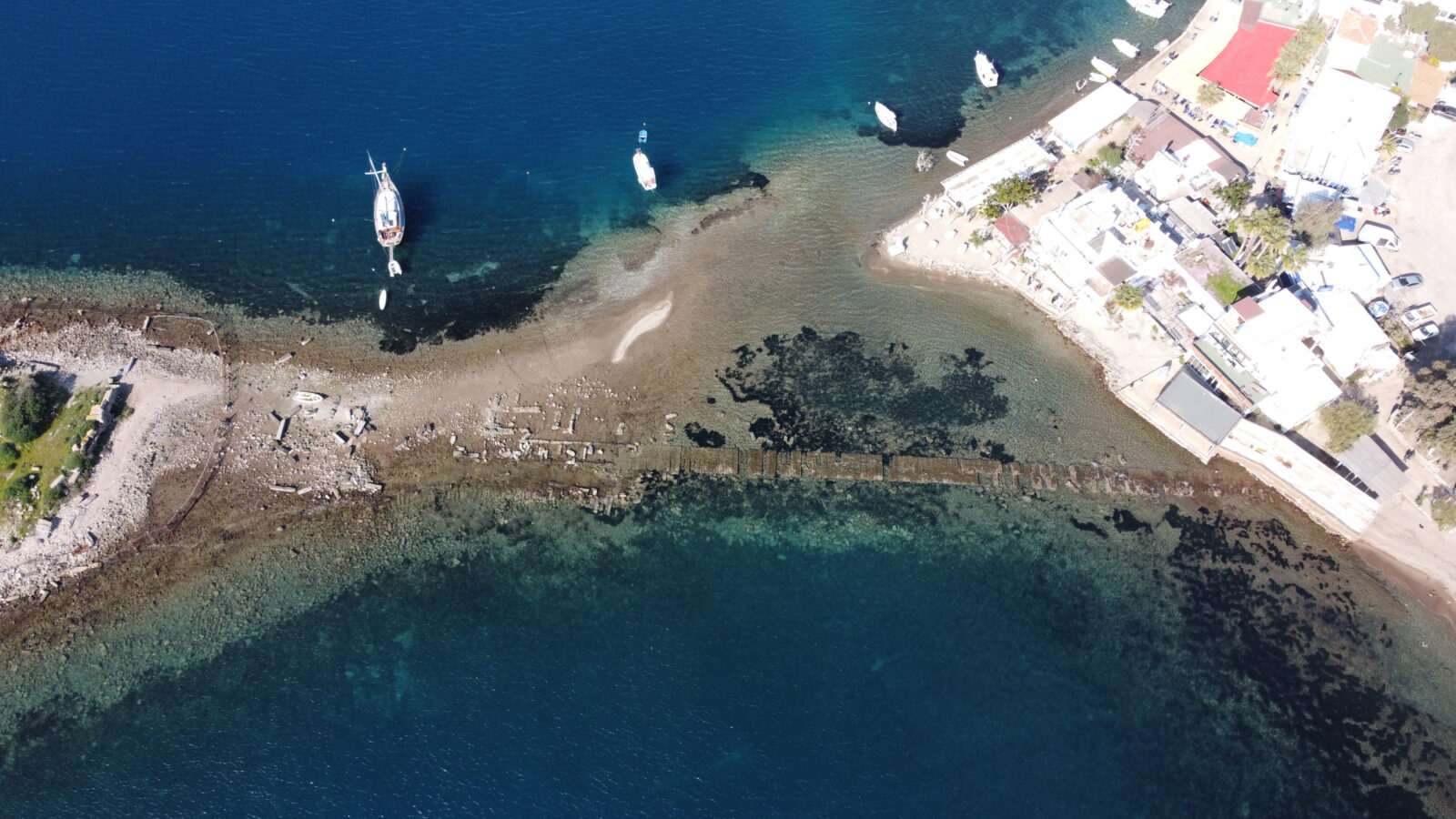 Historical remnants of a city wall extending to Rabbit Island in Bodrum, Mugla, emerged as the sea receded. The wall was captured in aerial footage by UAV, Türkiye, Feb. 8, 2025. (AA Photo)