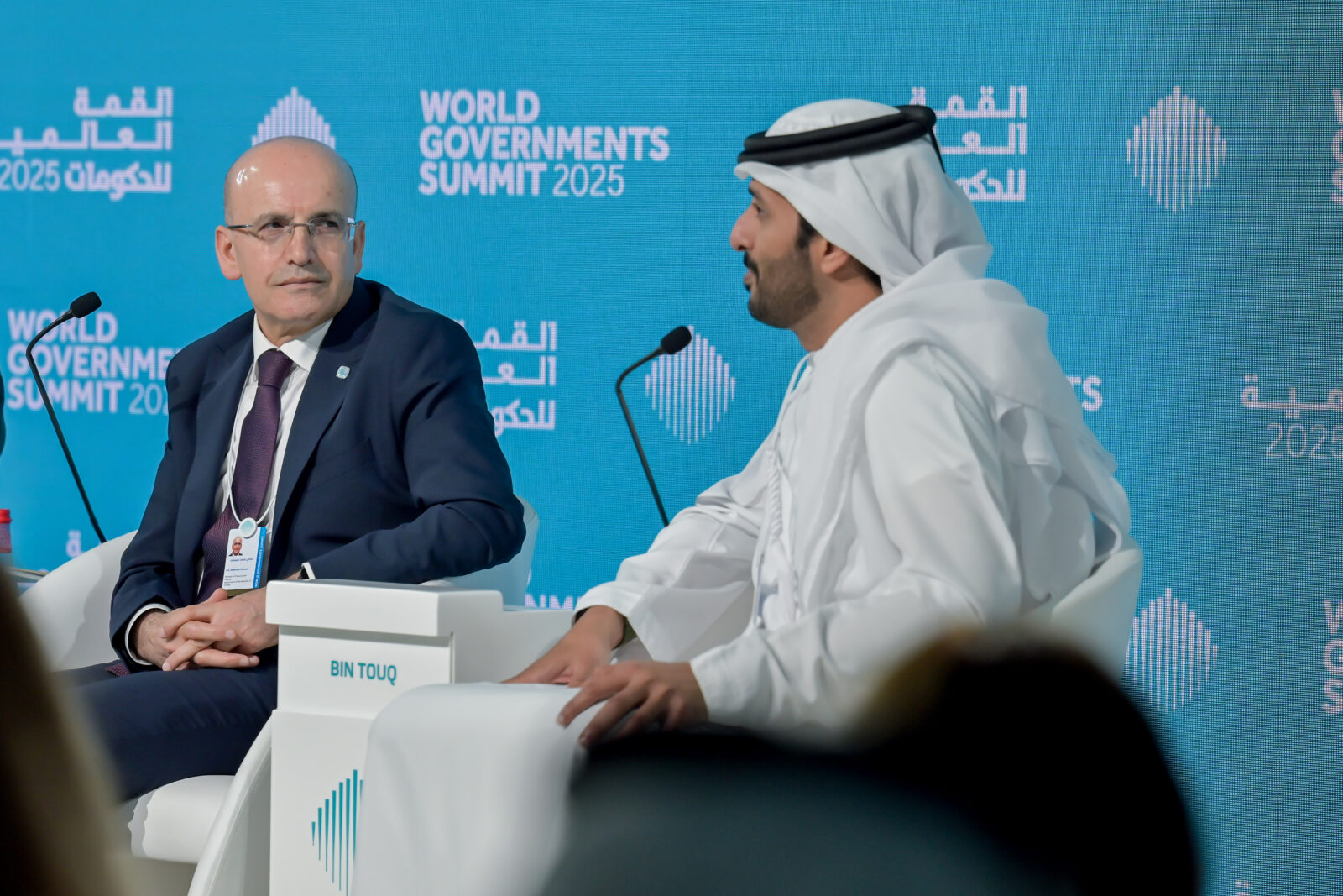 Türkiye's Treasury and Finance Minister Mehmet Simsek (L), delivers a speech on a panel entitled 