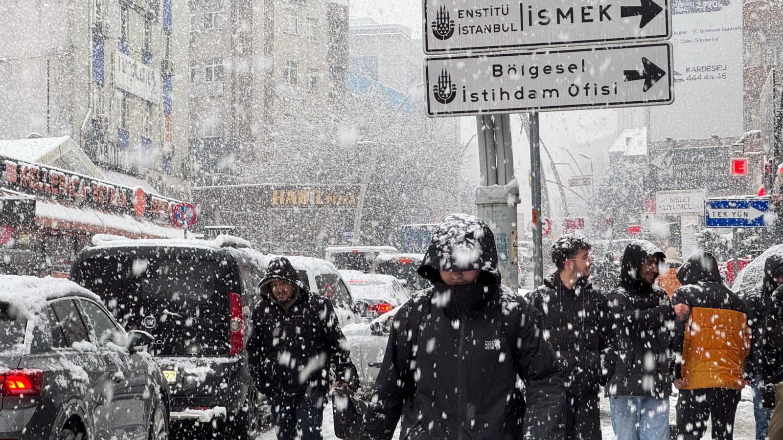 People walk as a sudden afternoon snowfall impacts Istanbul, Türkiye, Feb. 19, 2025. (AA Photo)