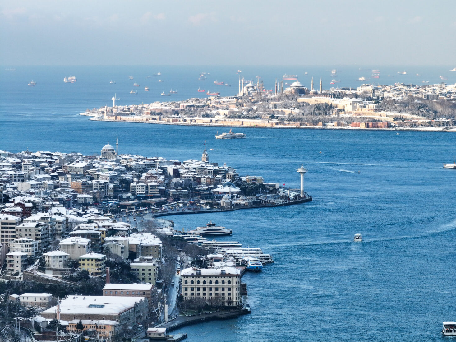 An aerial view shows snow covered residential areas and Bosphorus after intermittent snowfall in Istanbul, Türkiye, Feb. 21, 2025. (AA Photo)
