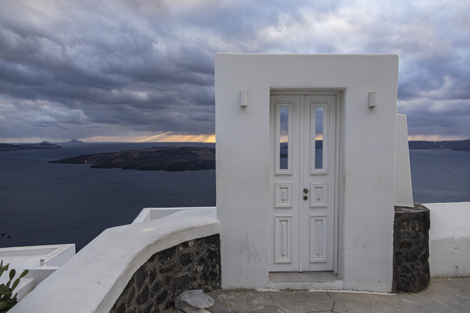 A door leading to a hotel with Nea Kammeni islet visible in the background on the Greek island of Santorini, Feb. 21, 2025. (AA Photo)
