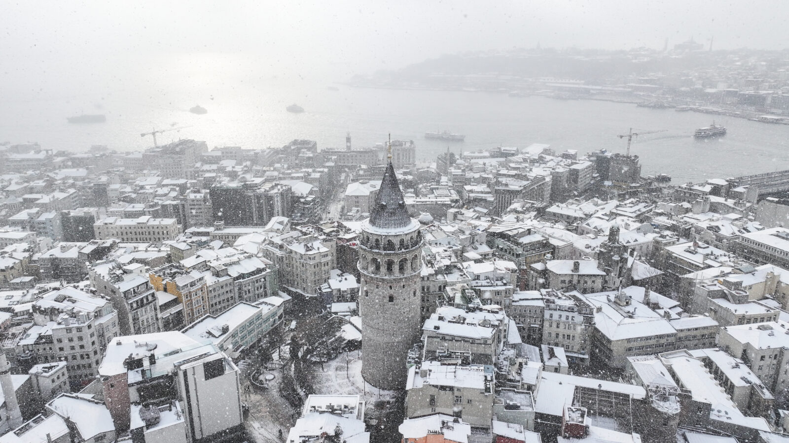 An aerial view of Galata Tower and its surroundings as snowfall continues in Istanbul, Türkiye, on February 23, 2025. (AA Photo)
