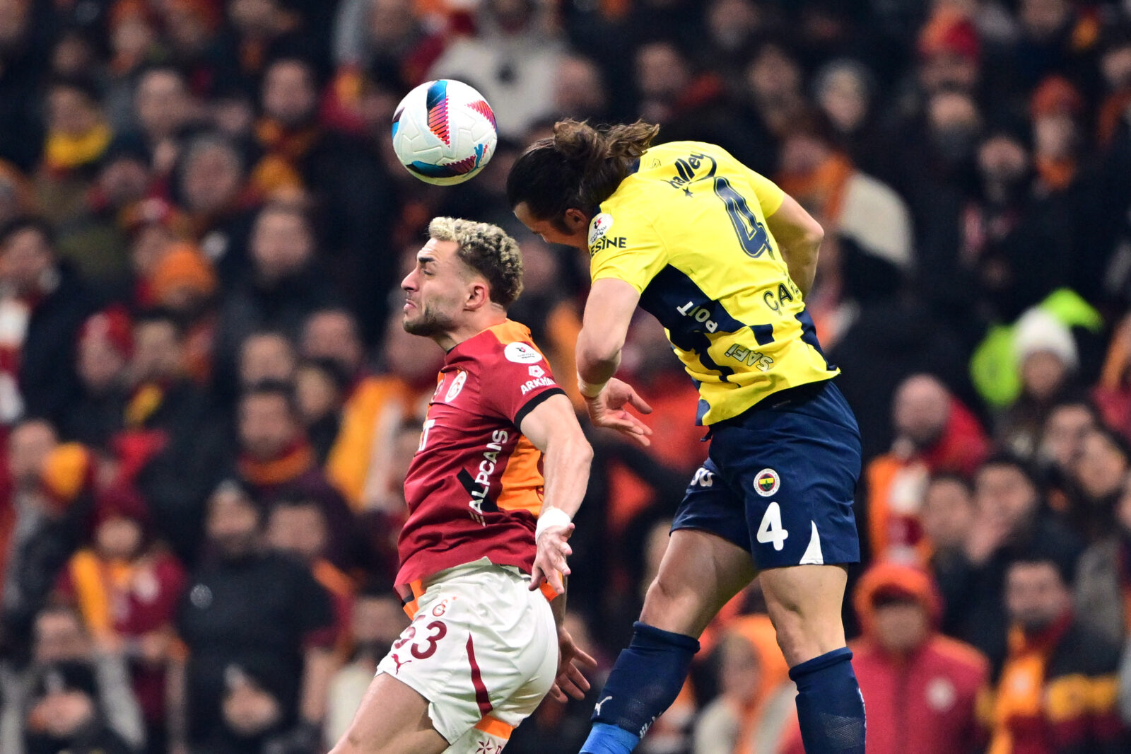 Baris Alper Yilmaz (53) of Galatasaray in action against Caglar Soyuncu (4) of the Turkish Super Lig week 25 football match between Galatasaray and Fenerbahce at RAMS Park in Istanbul, Türkiye, Feb. 24, 2025. (AA Photo)