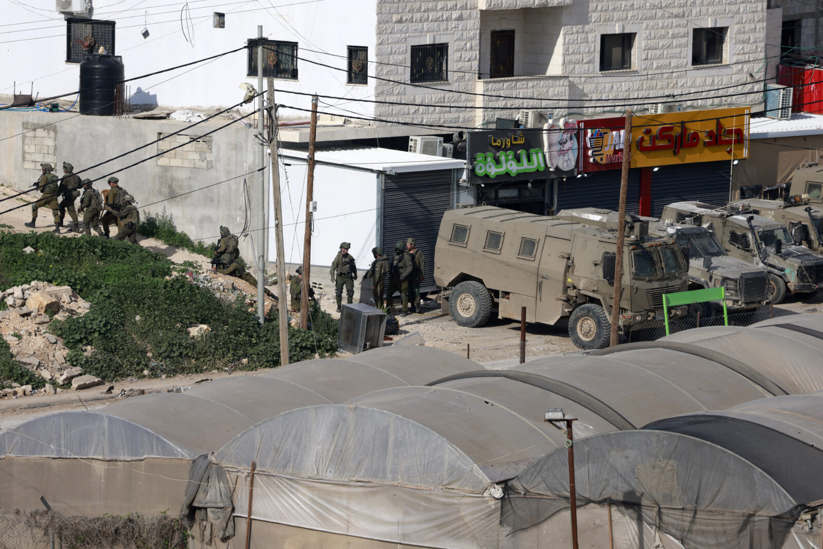Israeli soldiers take up a position during a military raid in the al-Fara camp for Palestinian refugees, south of Jenin in the occupied West Bank on Feb. 2, 2025. (AFP Photo)