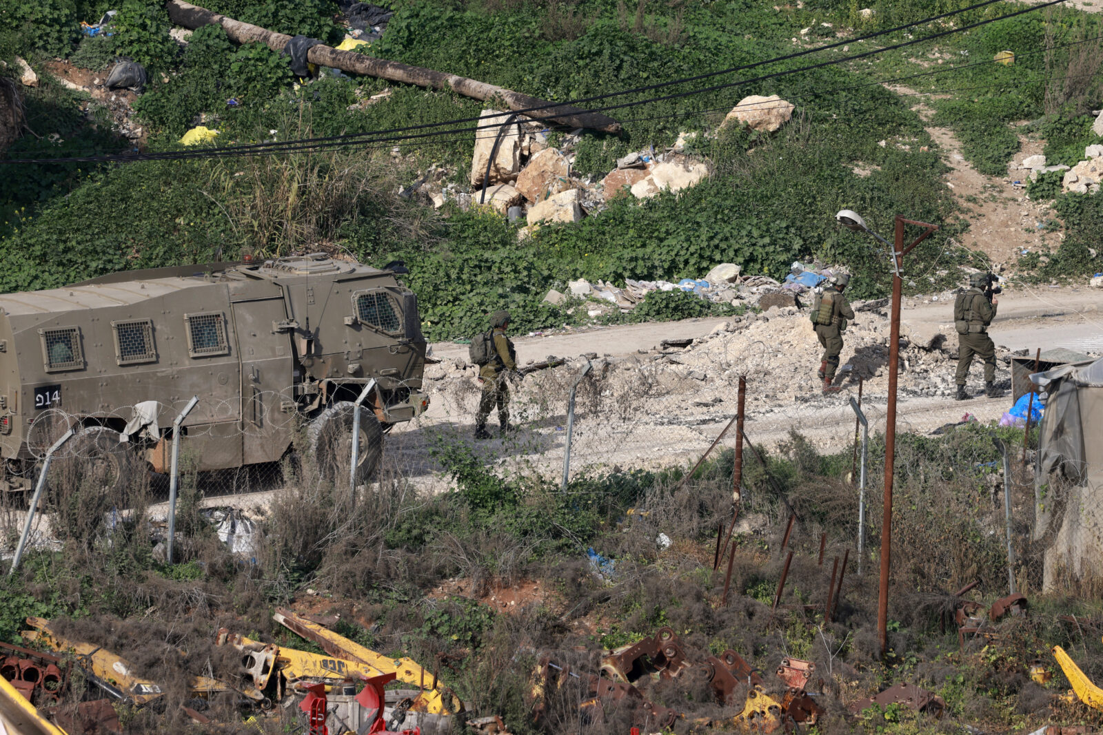 Israeli soldiers walk along a road during a military raid in the al-Fara camp for Palestinian refugees, south of Jenin in the occupied West Bank on Feb. 2, 2025. (AFP Photo)