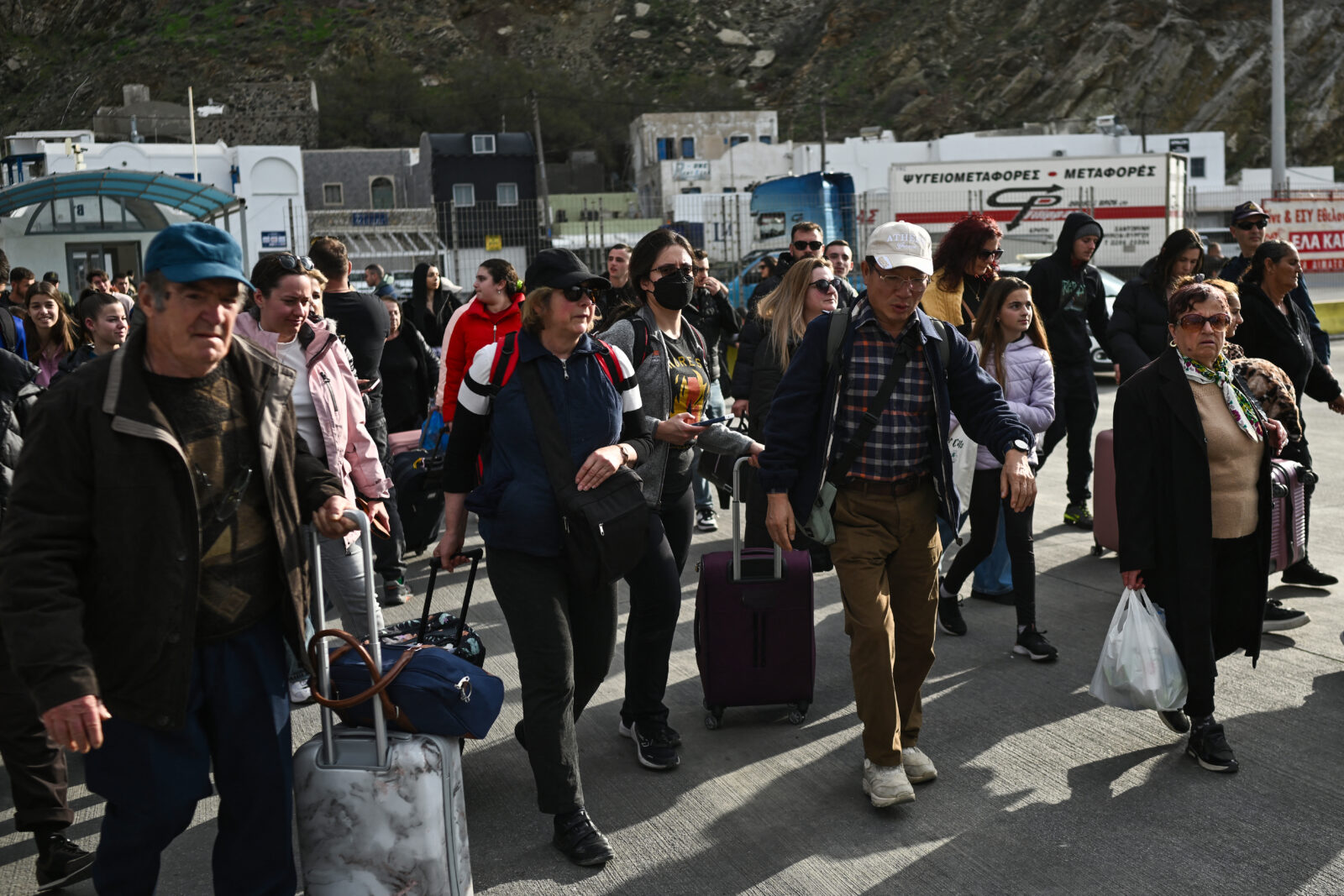 People walk to embark a ferry at the port on the Greek Island of Santorini on February 3, 2025, to leave in the wake of recurring earthquakes. (AFP Photo)
