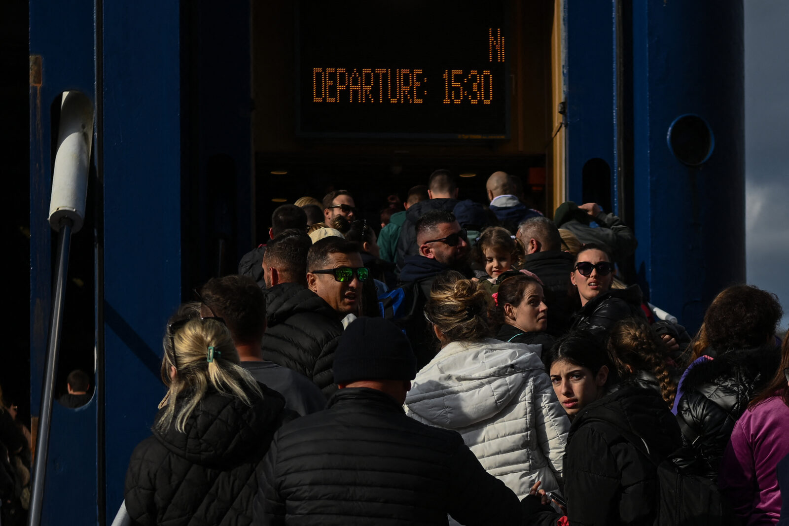 People embark on a ferry at the port on the Greek Island of Santorini on February 3, 2025. (AFP Photo)