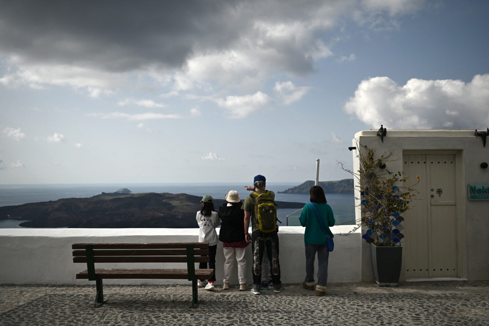 Bystanders look out over the sea from a point in Fira, on the Greek Island of Santorini on Feb. 3, 2025. (AFP Photo)