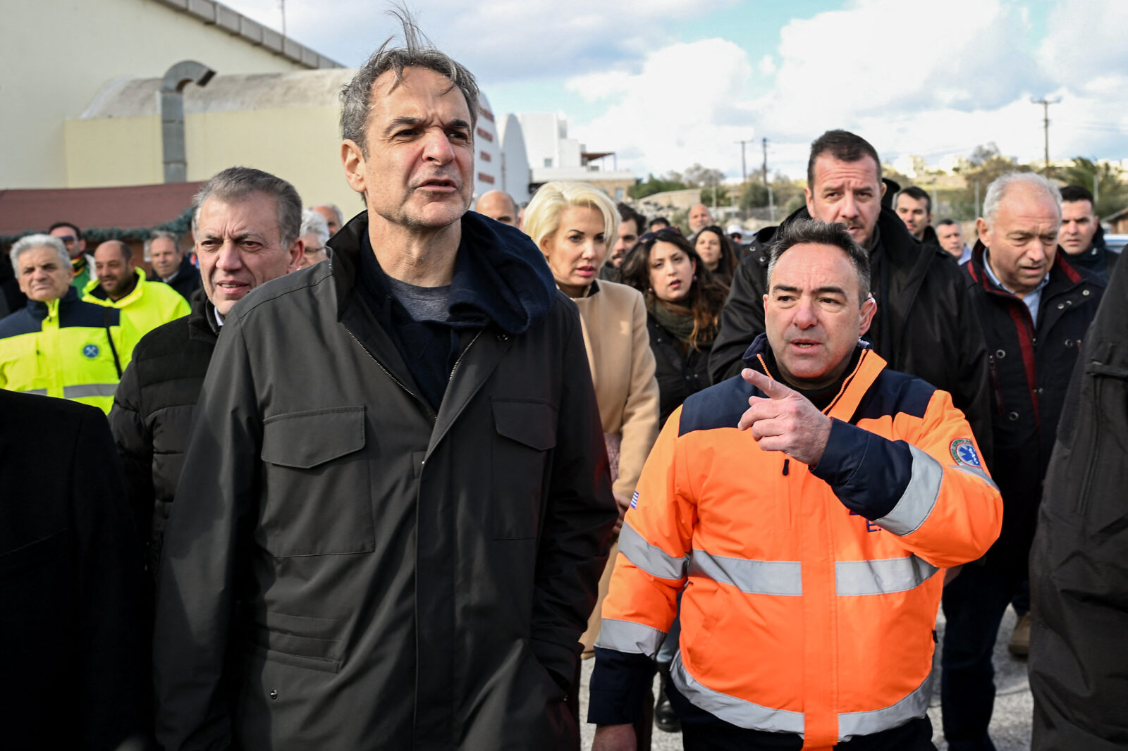 Greece's Prime Minister Kyriakos Mitsotakis (C) listens to explanations following earthquakes in Santorini as he visits the rescue team of the Greek firefighting department in the town of Fira on the Aegean island of Santorini, Greece, February 7, 2025. (AFP Photo)
