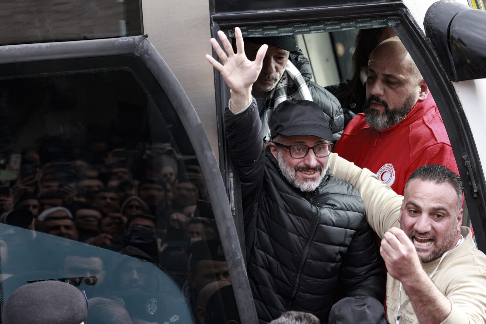 A former Palestinian prisoner released by Israel waves to a cheering crowd as he steps out of a bus in the occupied West Bank city of Ramallah on Feb. 8, 2025 (AFP Photo)