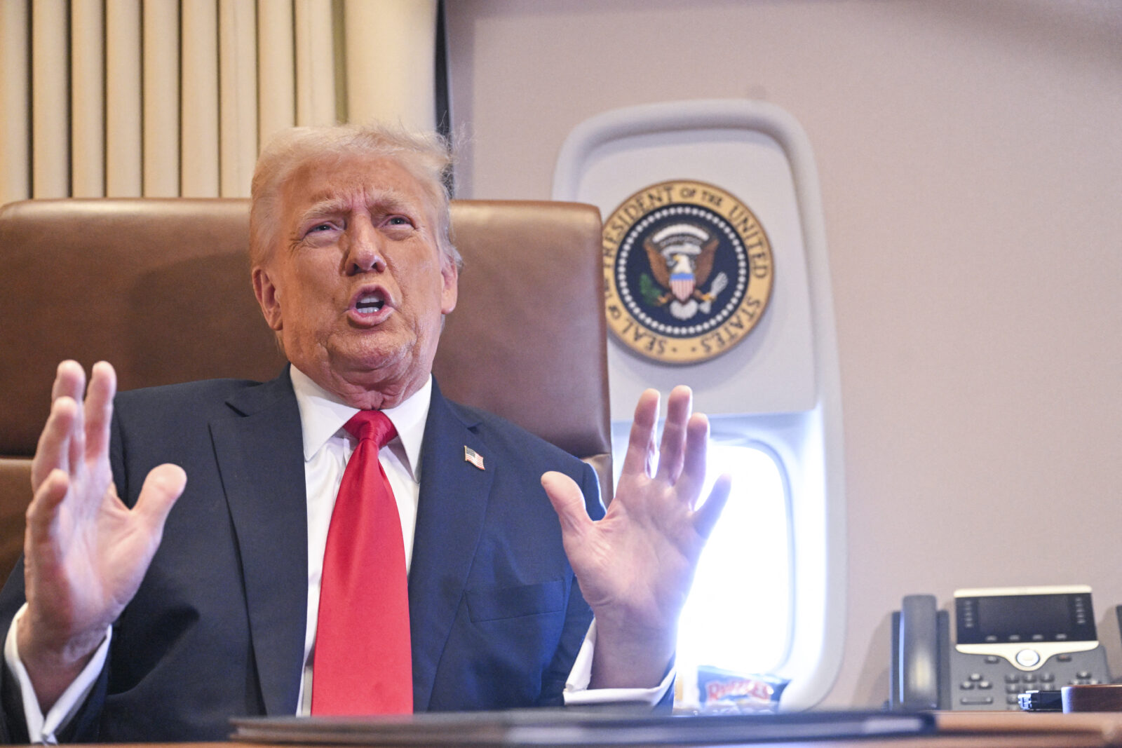 US President Donald Trump speaks to the press after signing a proclamation renaming the Gulf of Mexico as the Gulf of America aboard Air Force One, as it flies over the Gulf en route to New Orleans, Louisiana on Feb.9, 2025. (AFP Photo)