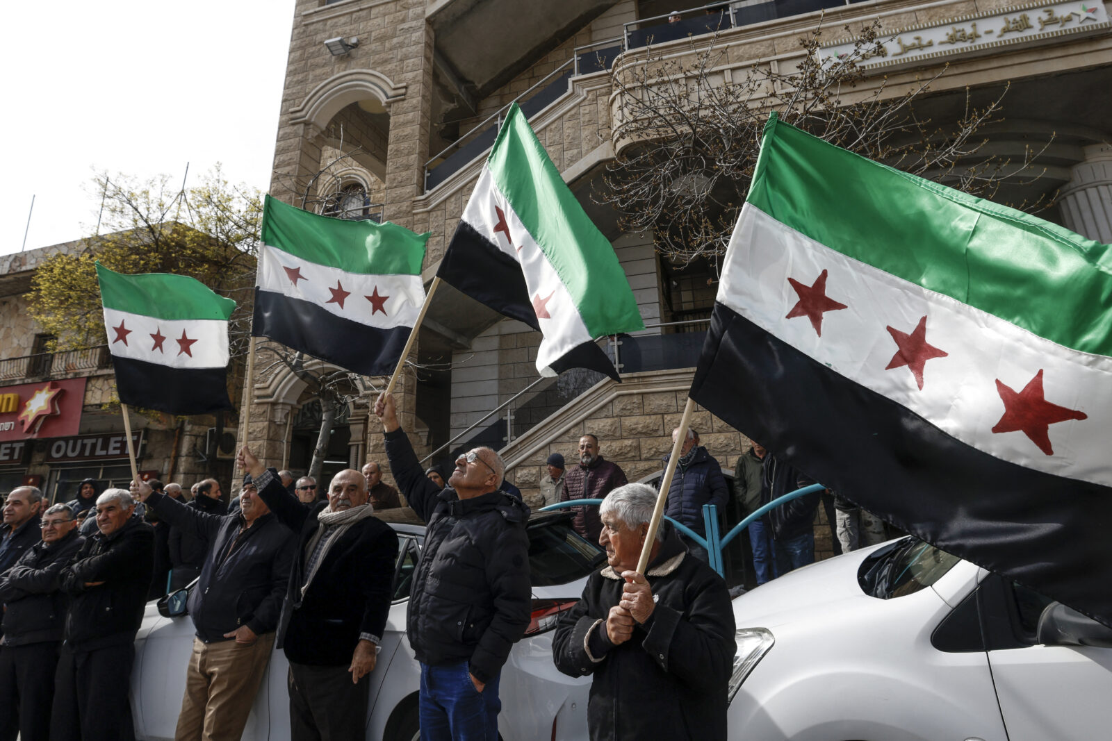 Druze residents of the village of Majdal Shams in the Israeli-annexed Golan Heights wave Syrian flags as they take part in a rally on Feb. 14, 2025, to protest against the 1981 annexation law of the strategic plateau which Israel captured from Syria during the 1967 Arab-Israeli war. (AFP Photo)