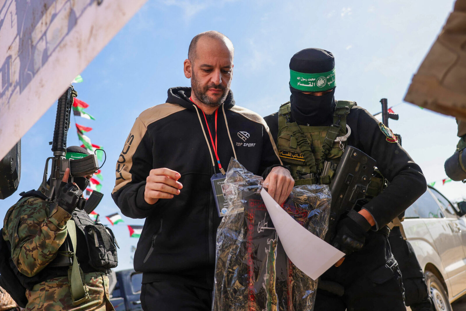 Hamas members escort Israeli-Argentinian hostage Yair Horn on a stage before handing him over to a Red Cross team in Khan Yunis, southern Gaza Strip, on February 15, 2025 (AFP Photo)