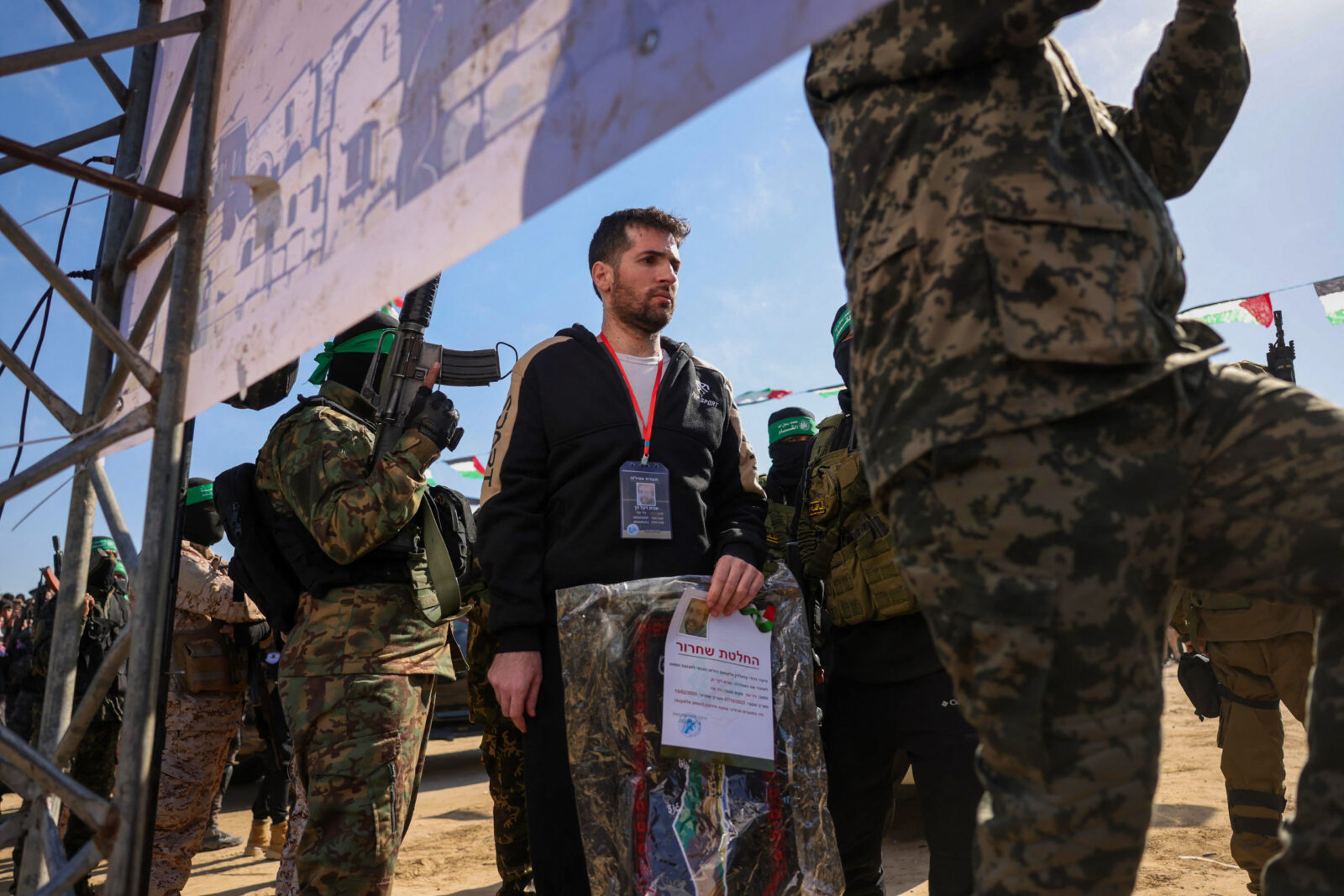 Hamas members escort Israeli-American hostage Sagui Dekel-Chen on a stage before handing him over to a Red Cross team in Khan Yunis, southern Gaza Strip, on February 15, 2025. (AFP Photo)