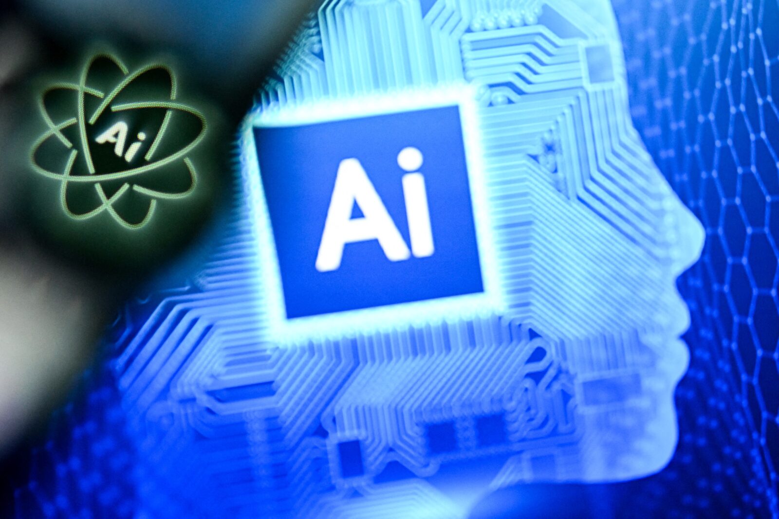 The letters AI for Artificial Intelligence on a laptop screen (R) next to the logo of the Chat AI application on a smartphone screen in Frankfurt am Main, western Germany on January 2, 2025 (AFP Photo)