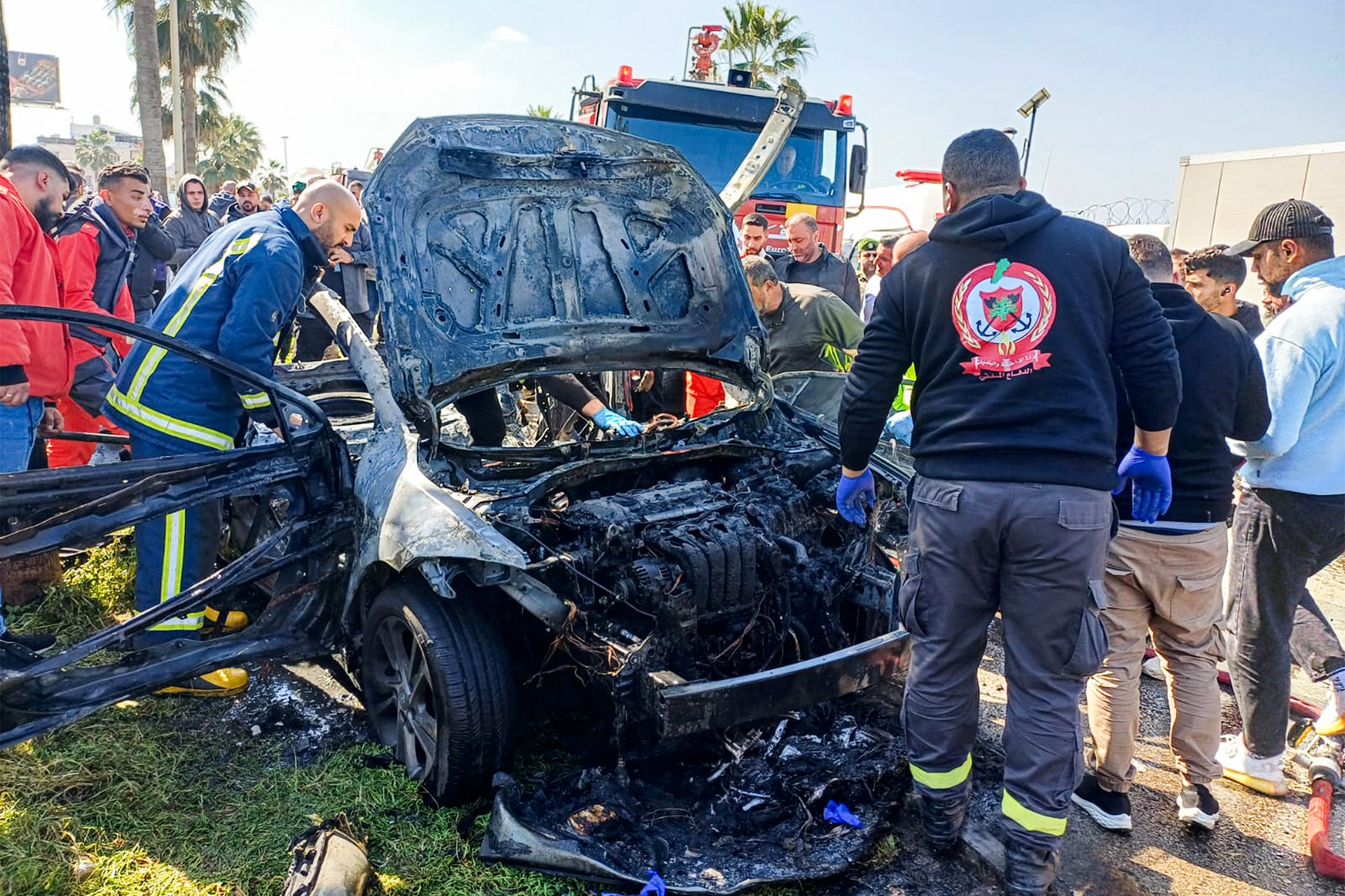 Lebanese army, security forces, and civil defence first responders inspect the remains of a destroyed vehicle that was reportedly hit by an Israeli strike in Lebanon's southern city of Sidon on February 17, 2025. (AFP Photo)