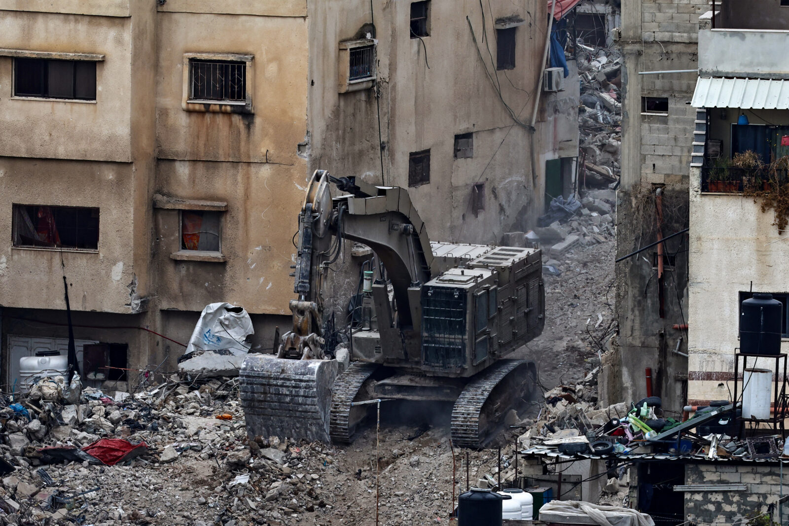 An Israeli bulldozer tears up a street during an ongoing raid in the Tulkarem camp for Palestinian refugees in the occupied West Bank on February 19, 2025. (AFP Photo)