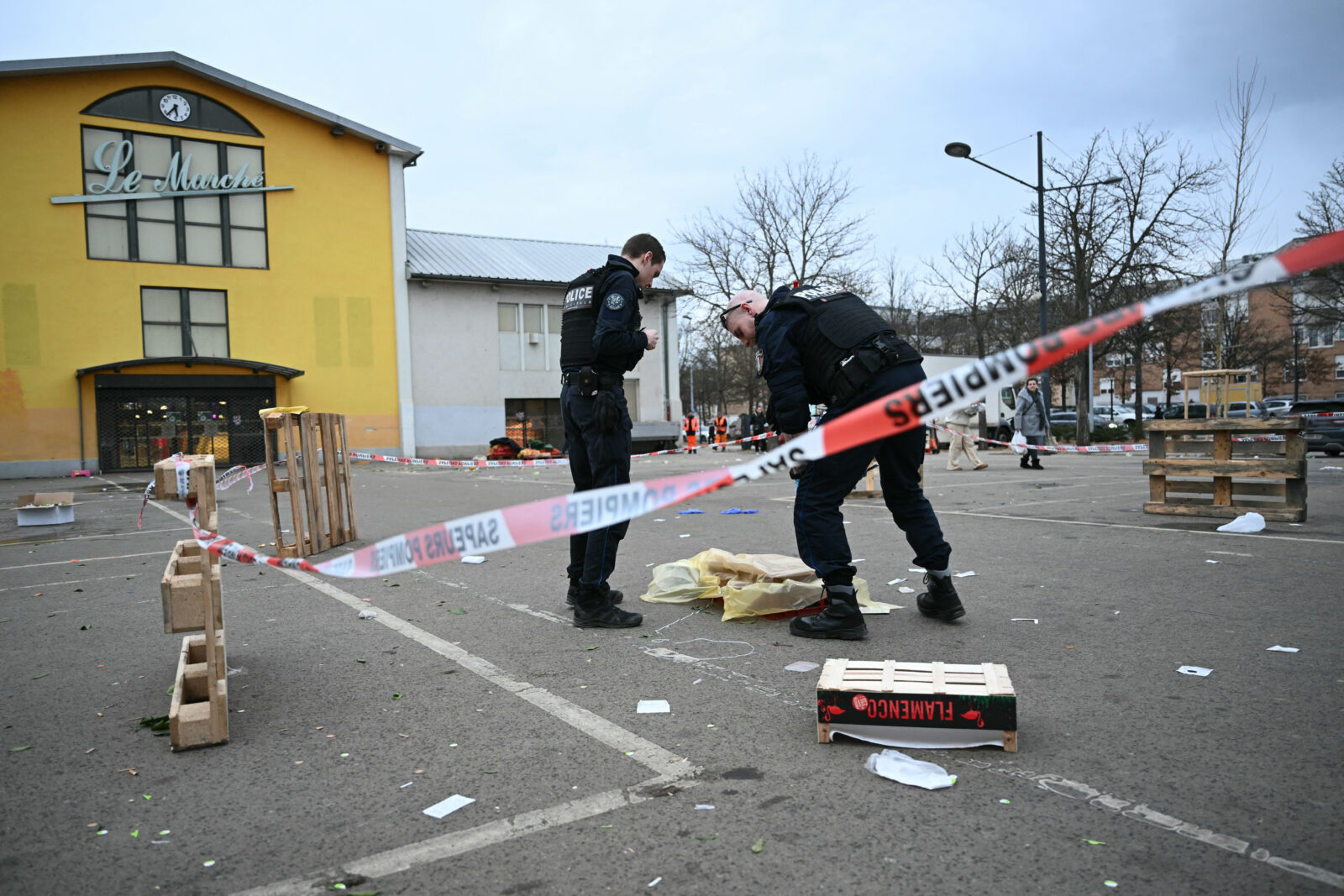 French municpal Police officers work to collect evidence at the site of a bladed weapon attack where a man is suspected of killing one person and wounding two municipal police officers in Mulhouse, eastern France on Feb. 22, 2025. (AFP Photo)
