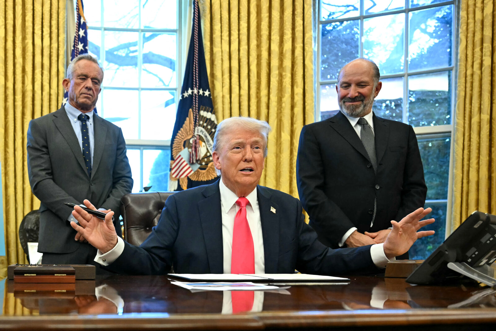 U.S. President Donald Trump speaks to the press after signing an Executive Order, alongside U.S. Secretary of Health and Human Services Robert F. Kennedy Jr. (L) and U.S. Secretary of Commerce nominee Howard Lutnick (R), at the Oval Office of the White House in Washington, D.C. on Feb. 25, 2025. (AFP Photo)