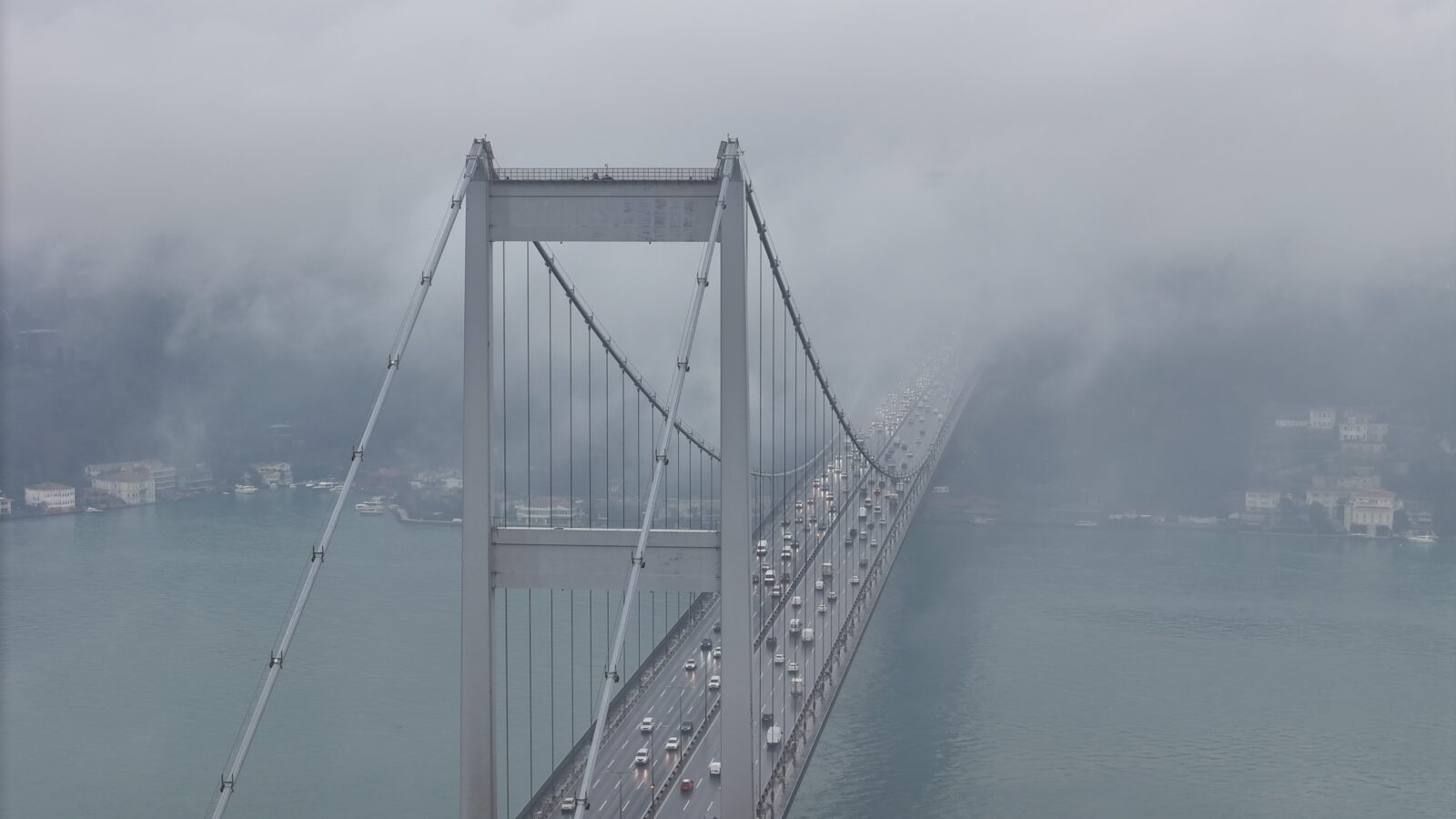 Dense fog over the Bosphorus partially obscured the 15 July Martyrs Bridge, creating a stunning view captured by a drone, Istanbul, Türkiye, Feb. 11, 2025. (IHA Photo)