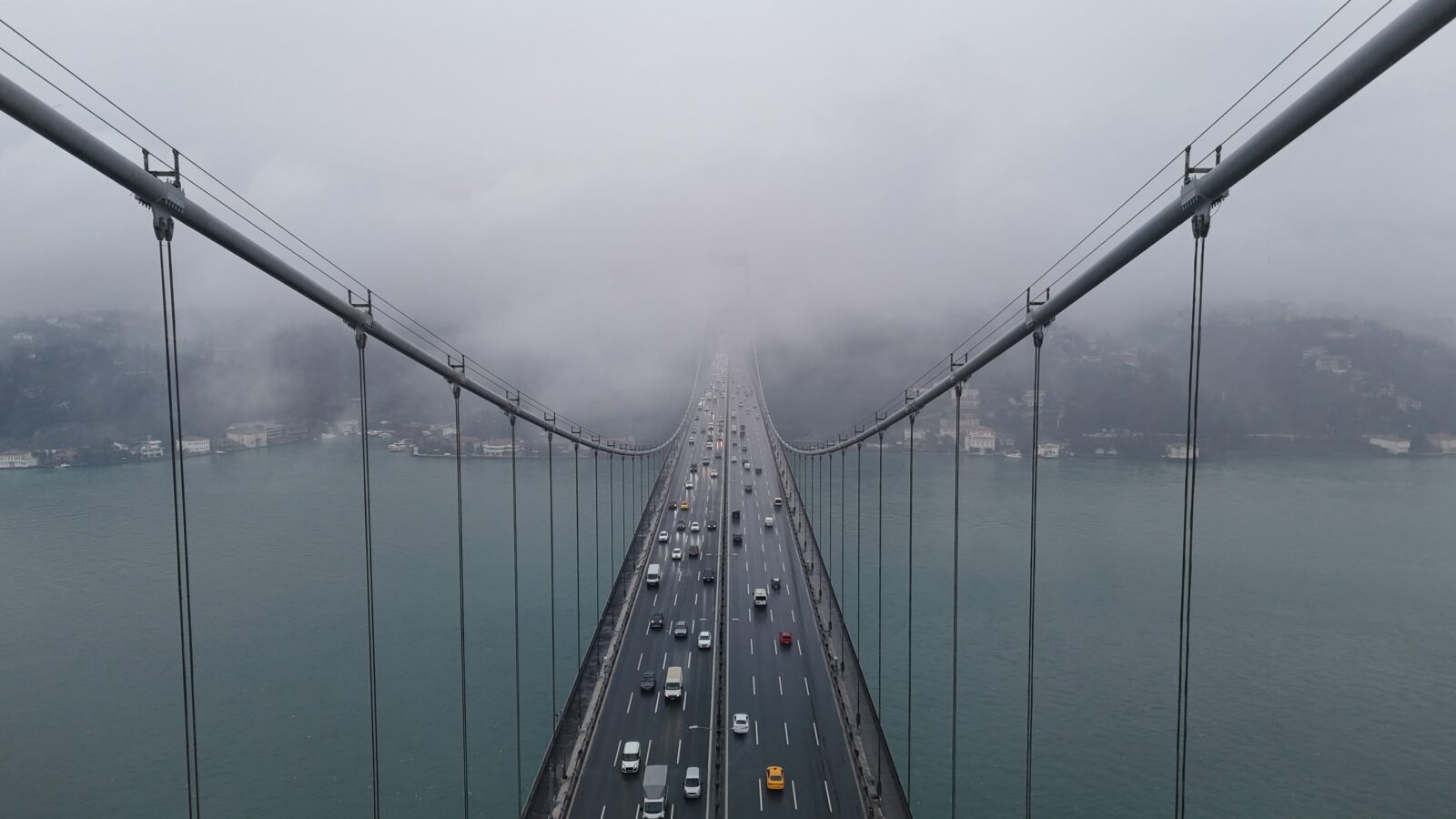 Dense fog over the Bosphorus partially obscured the 15 July Martyrs Bridge, creating a stunning view captured by a drone, Istanbul, Türkiye, Feb. 11, 2025. (IHA Photo)