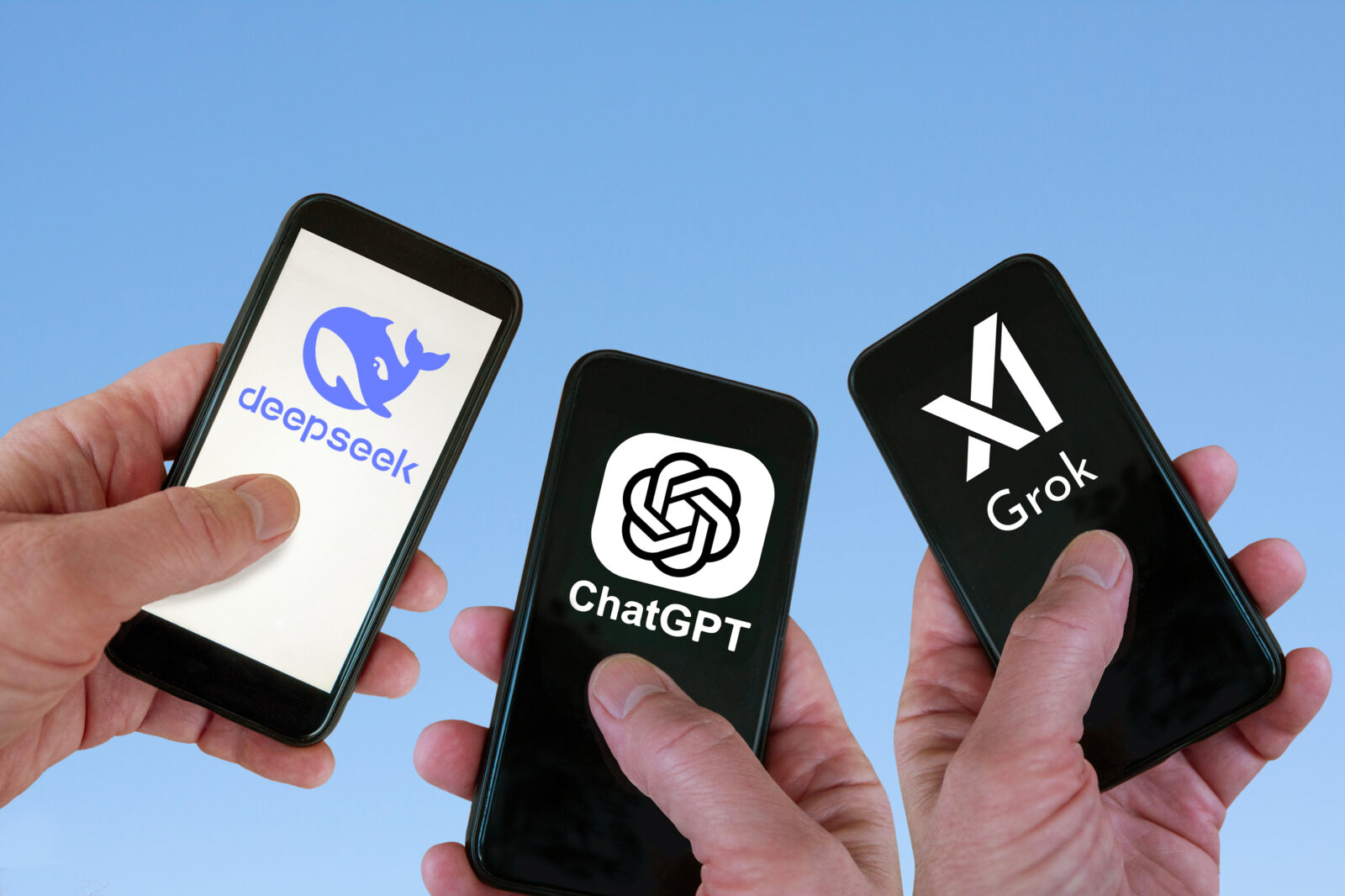 A photo illustration shows three smartphones side by side displaying AI chatbot competitors DeepSeek, ChatGPT, and Grok. (Adobe Stock Photo)