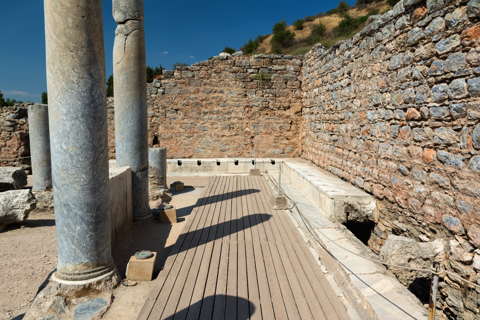Ancient public toilets/latrina in Ephesus, Izmir, Türkiye. (Adobe Stock Photo)
