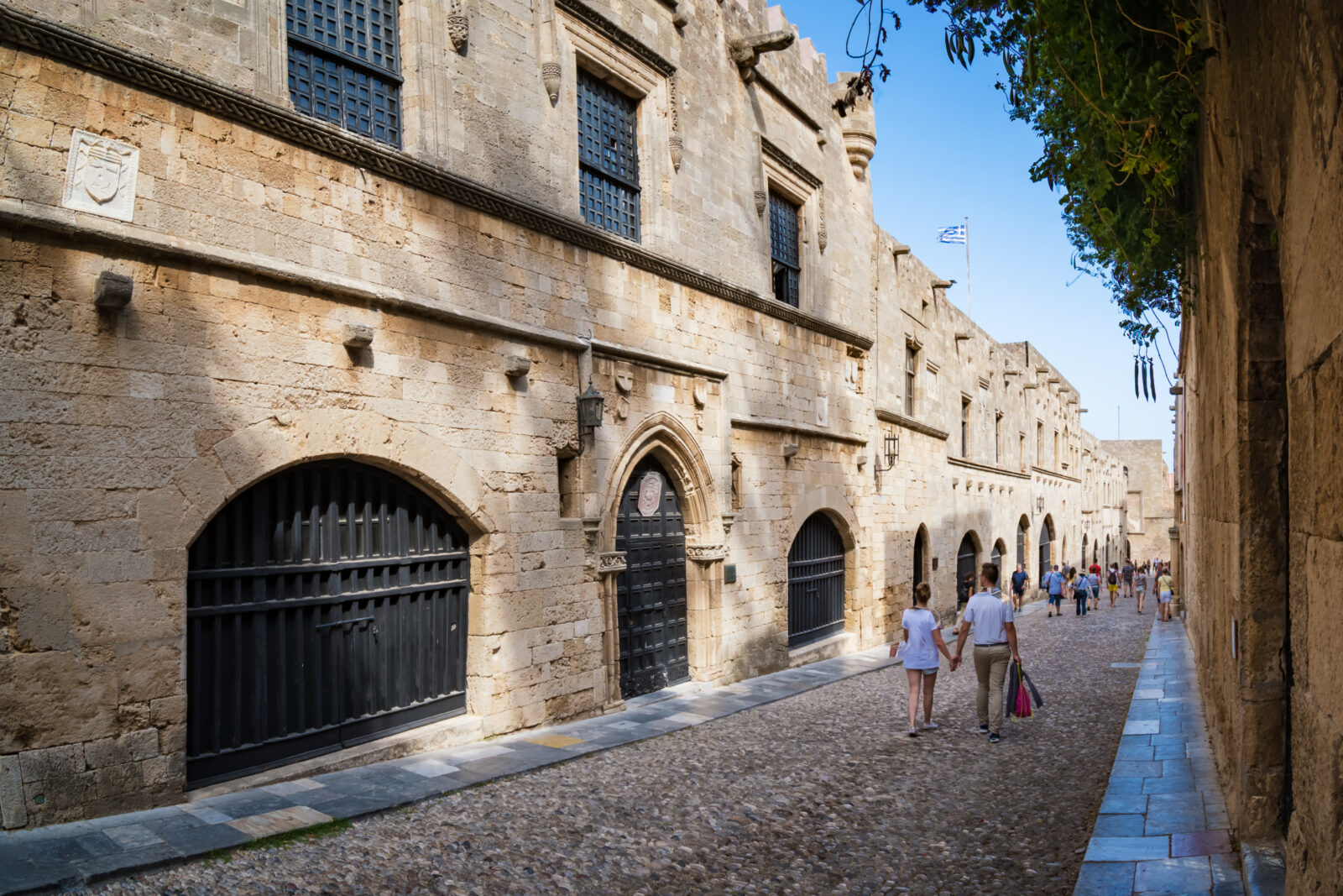 A couple strolling along the historic street of the Knights (Ippoton) in Rhodes, Greece. (Adobe Stock Photo)