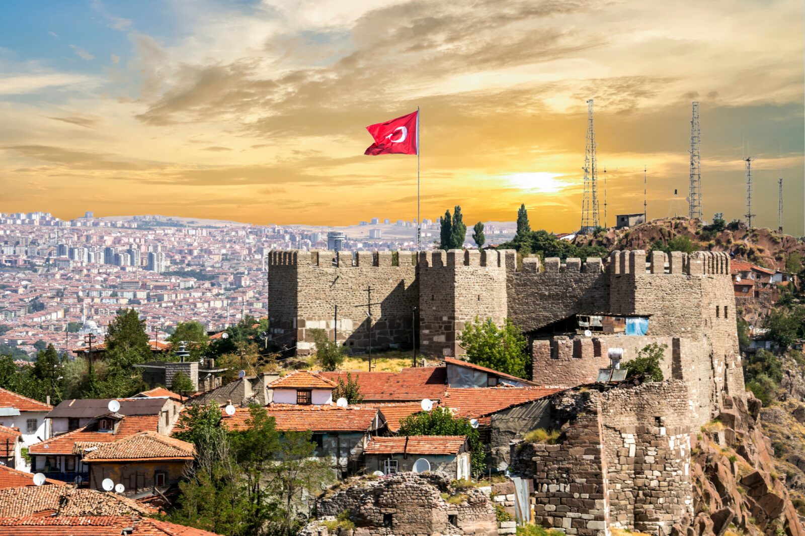 An aerial view of Ankara's famous castle and a Turkish flag, Türkiye. (Adobe Stock Photo)
