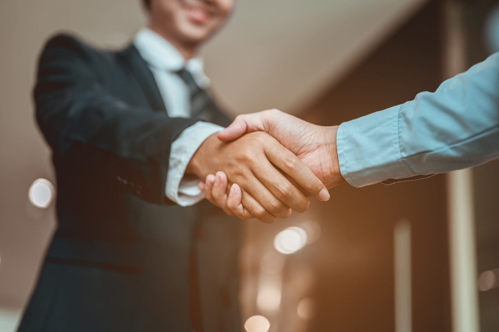 A close-up of a business handshake, symbolizing partnership, investment deals, and successful agreements. (Adobe Stock Photo)