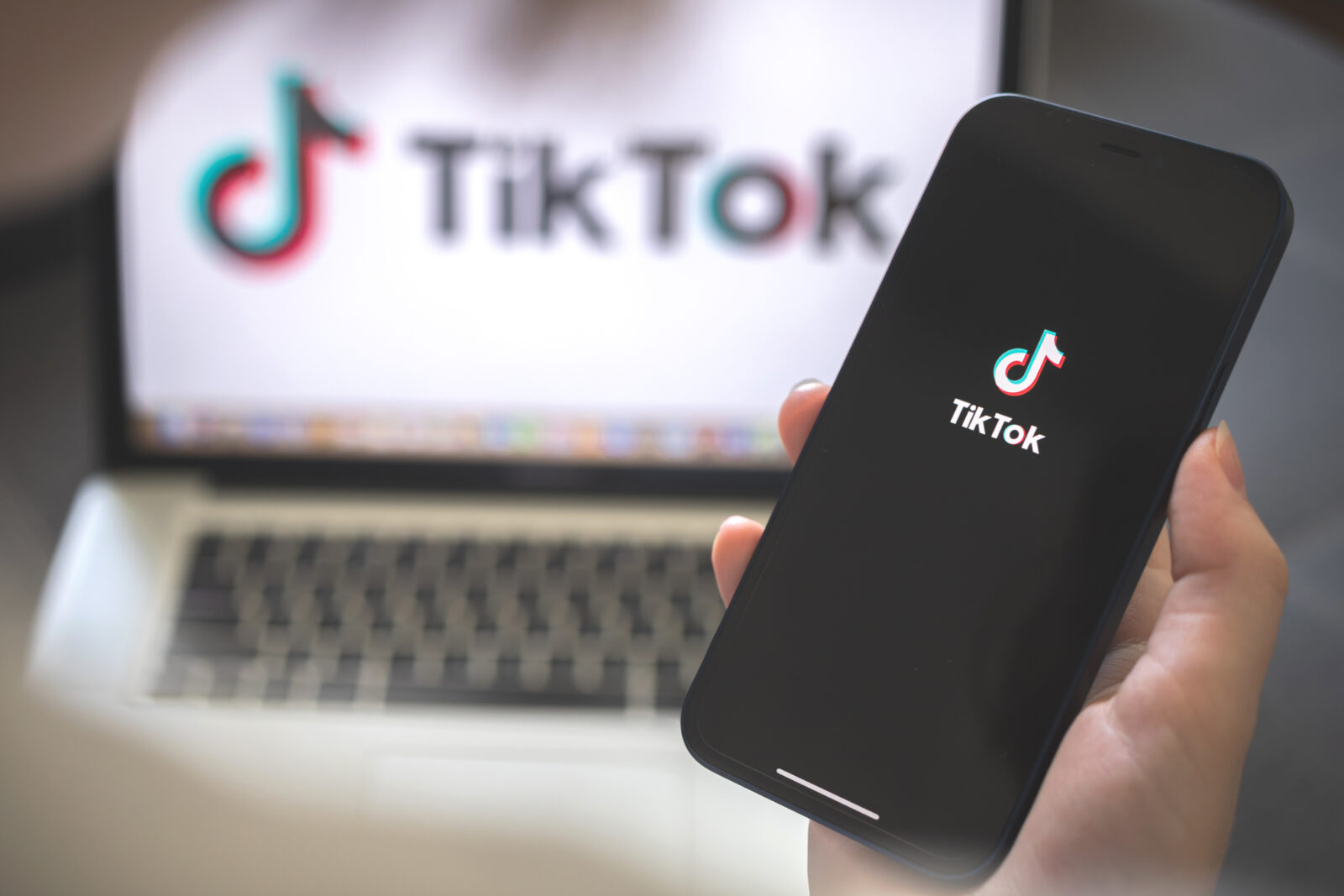 A person using a smartphone with a TikTok social media app on. (Adobe Stock Photo)