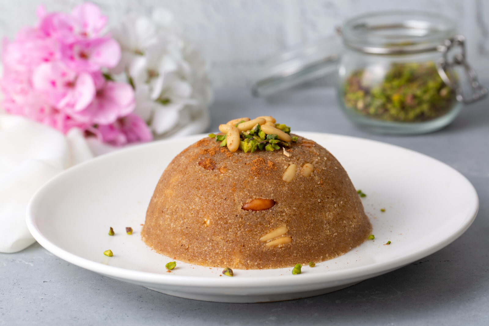 A comforting serving of irmik helvasi (Semolina Halva), topped with pine nuts and pistachios, is commonly prepared for special occasions in Türkiye. (Adobe Stock Photo)